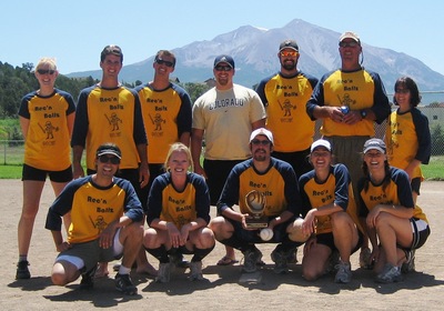 A Parks and Recreation baseball team showcases their custom jerseys and their trophy.