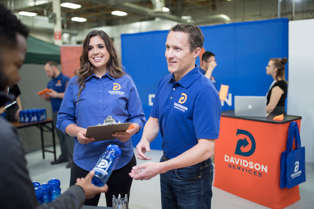 team at a trade show in branded apparel